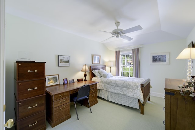 bedroom with light carpet, vaulted ceiling, and ceiling fan