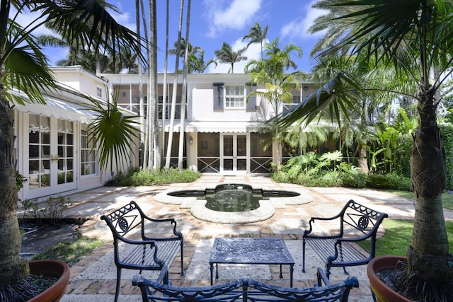 back of property with a patio area, a jacuzzi, and french doors