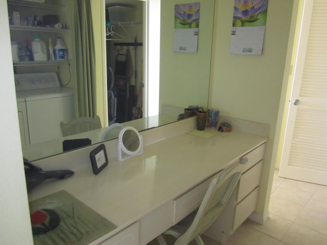 bathroom featuring washer / clothes dryer, tile patterned flooring, and vanity