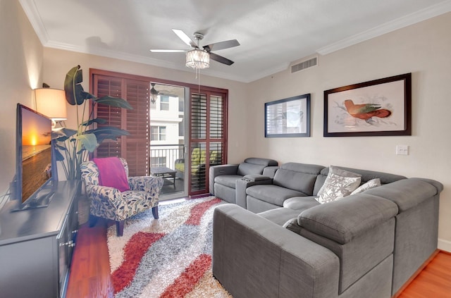 living room with ceiling fan, light hardwood / wood-style floors, and ornamental molding