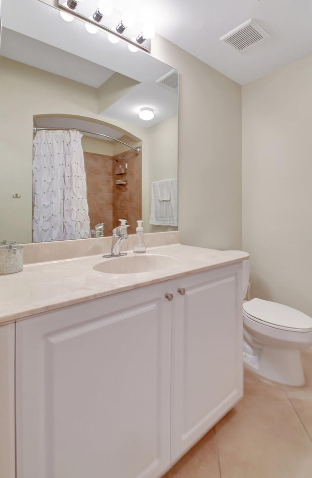 bathroom with toilet, vanity, tile patterned floors, and a shower with shower curtain