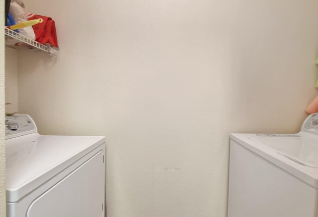 laundry room featuring washing machine and clothes dryer