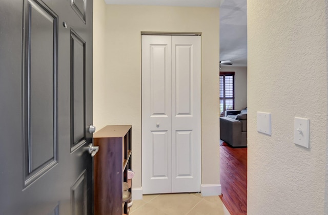 corridor featuring light tile patterned floors