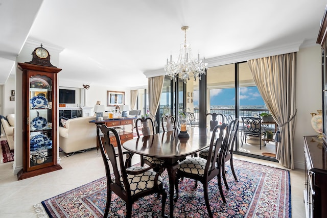 tiled dining area with an inviting chandelier and ornamental molding