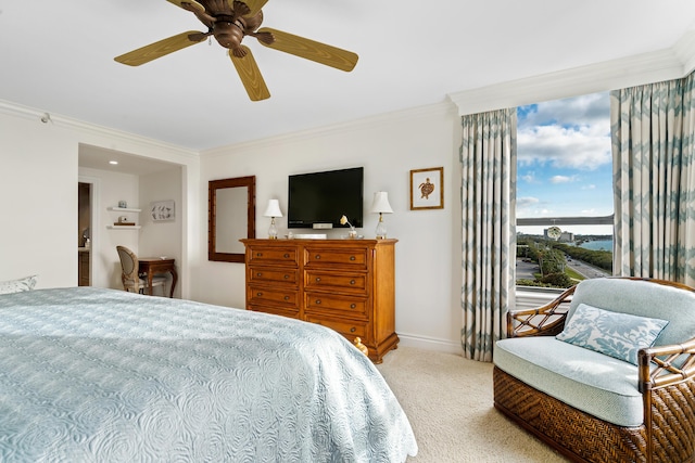 carpeted bedroom featuring ceiling fan and crown molding