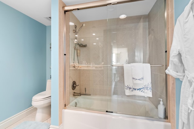 bathroom with tile patterned floors, toilet, and enclosed tub / shower combo