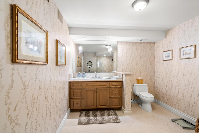 bathroom featuring tile patterned floors, vanity, and toilet