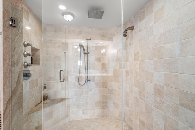 bathroom with a shower with door