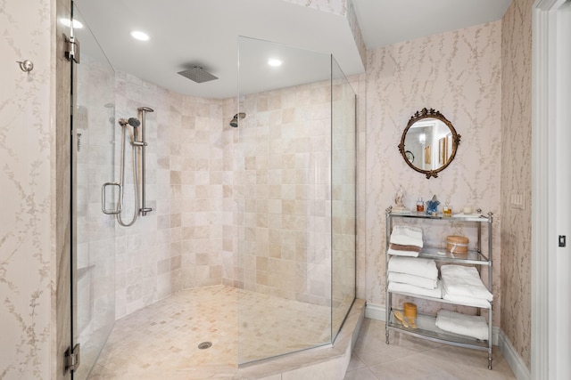 bathroom with tile patterned floors and a shower with door