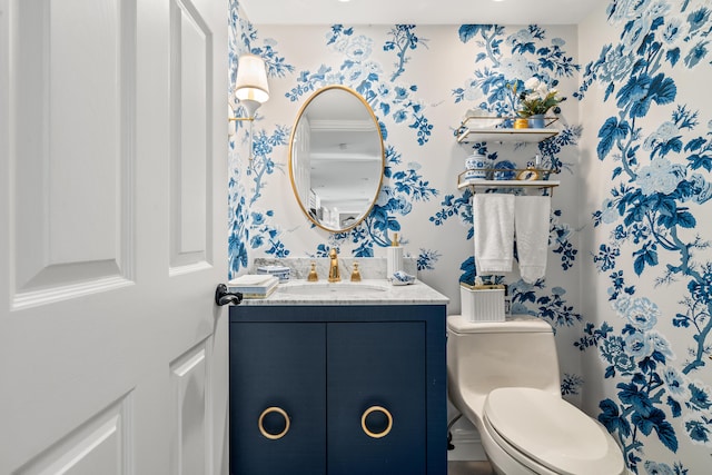 bathroom featuring vanity, toilet, and ornamental molding