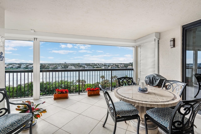 sunroom / solarium with a water view and plenty of natural light