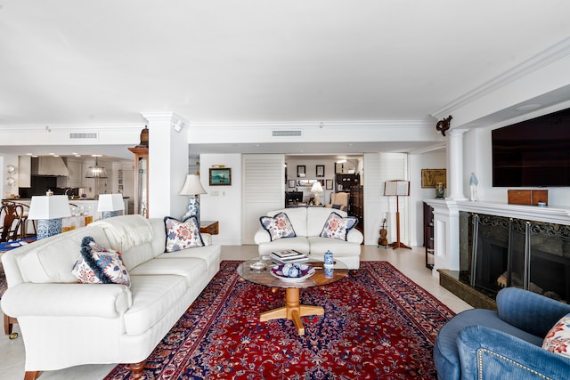 living room with a premium fireplace and ornamental molding