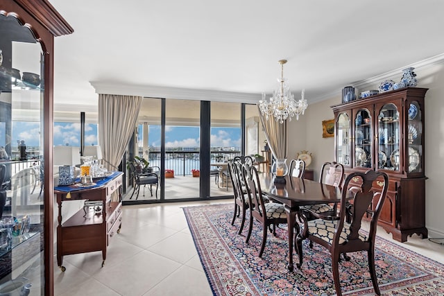 tiled dining space with a water view, a wall of windows, crown molding, and a chandelier