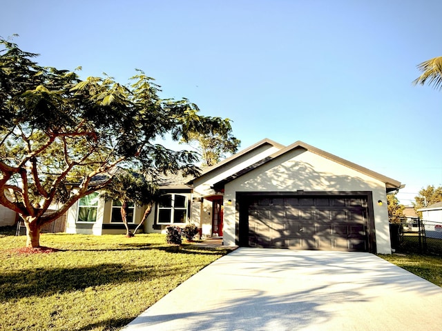 view of front of home featuring a garage and a front lawn