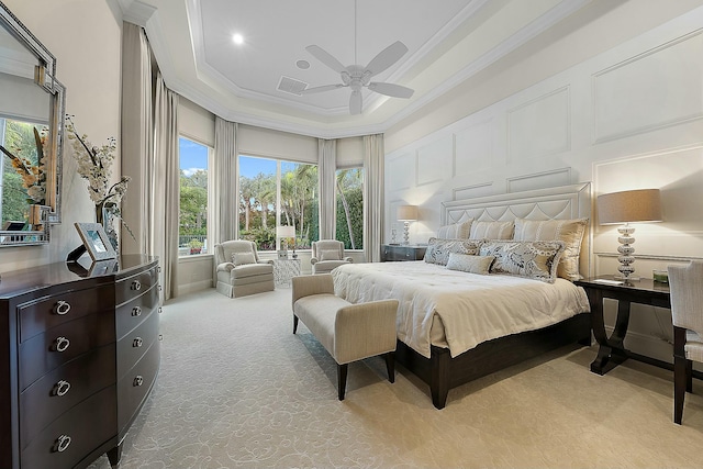 bedroom with ceiling fan, ornamental molding, a raised ceiling, and light carpet