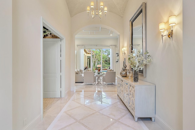 foyer with vaulted ceiling and a notable chandelier