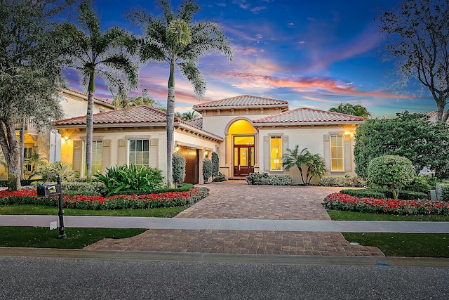 mediterranean / spanish house featuring a garage