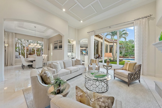 living room featuring a high ceiling, crown molding, coffered ceiling, and a chandelier