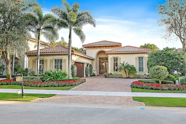 mediterranean / spanish-style house with a garage