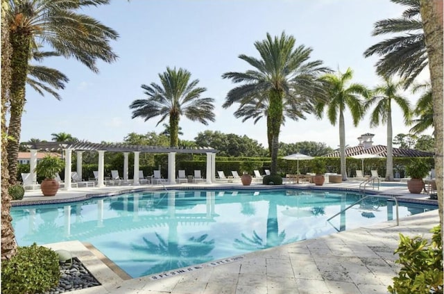 view of swimming pool with a pergola and a patio