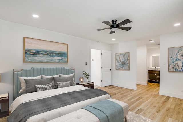 bedroom with ceiling fan and light hardwood / wood-style flooring