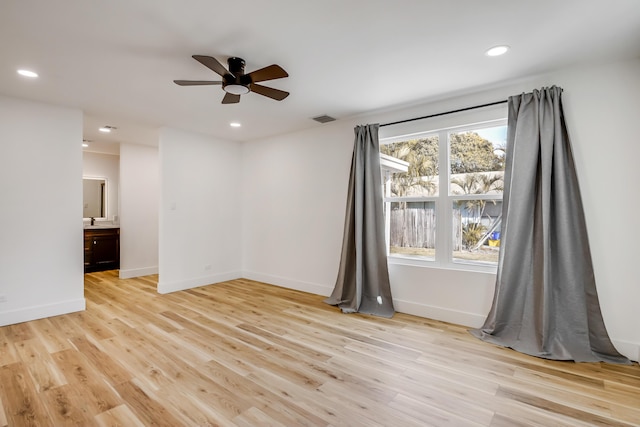 unfurnished room with ceiling fan and light hardwood / wood-style floors