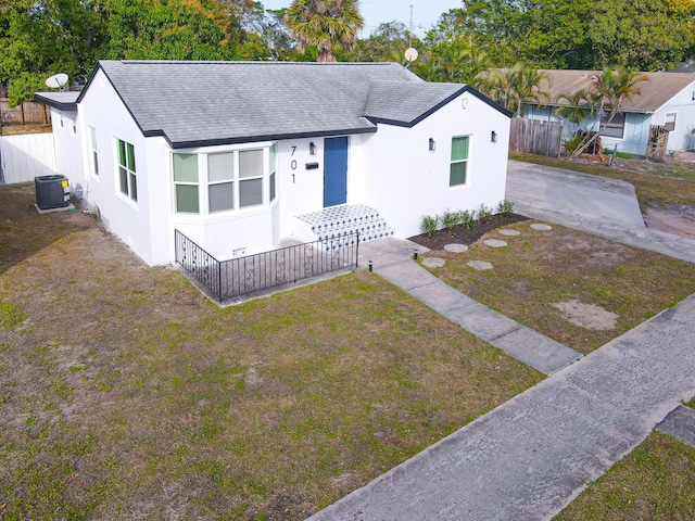 single story home featuring central AC and a front lawn