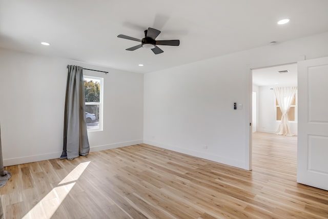 empty room with ceiling fan and light wood-type flooring