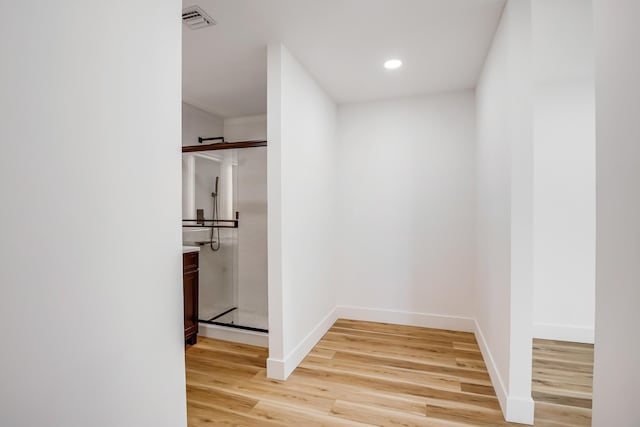 corridor with light wood-type flooring