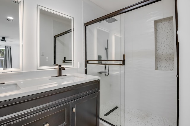 bathroom featuring vanity, ceiling fan, and a shower with shower door