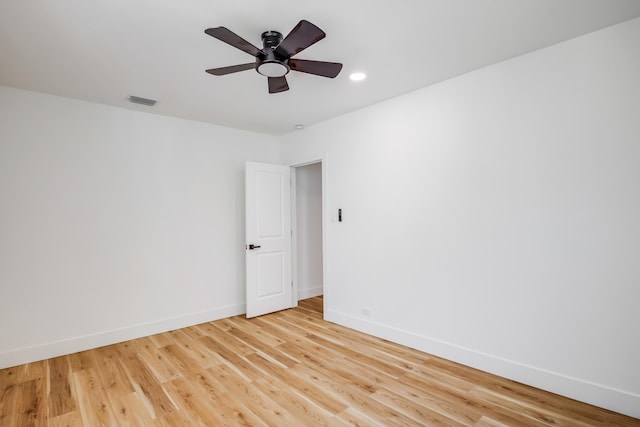 spare room featuring light wood-type flooring and ceiling fan