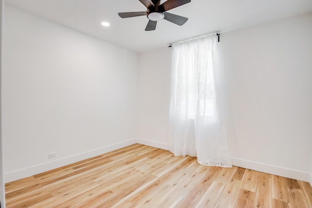 spare room featuring ceiling fan and hardwood / wood-style flooring