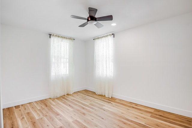 empty room with ceiling fan and light wood-type flooring