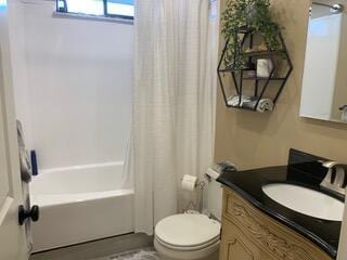 full bathroom with vanity, shower / bath combo, and toilet