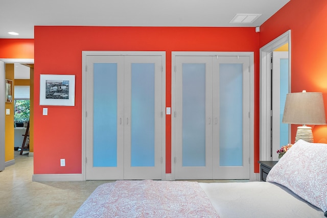 bedroom featuring multiple closets and french doors