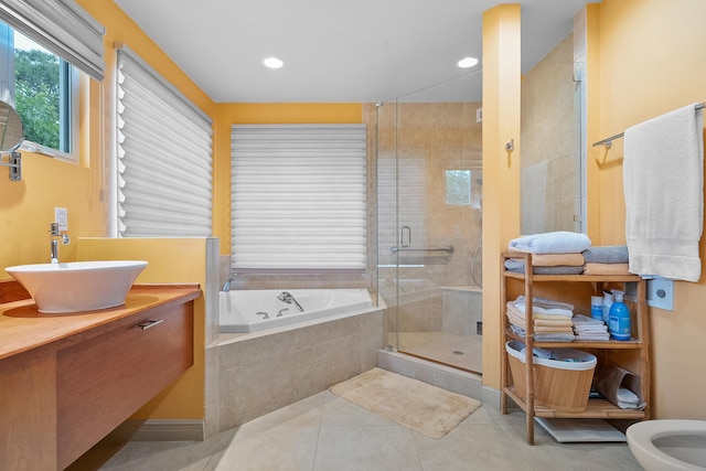 bathroom with a bidet, tile patterned flooring, shower with separate bathtub, and sink