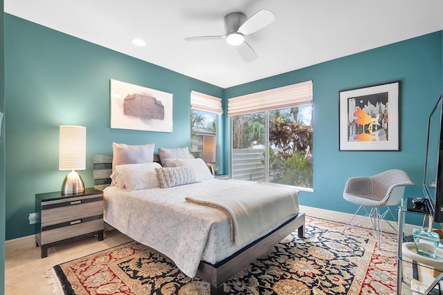 tiled bedroom featuring ceiling fan