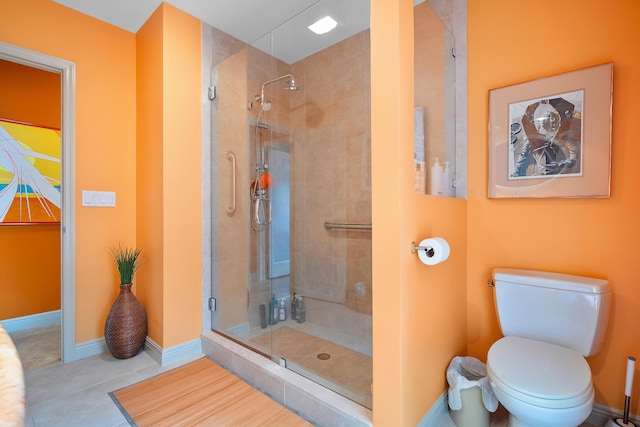 bathroom with toilet, a shower with door, and tile patterned flooring