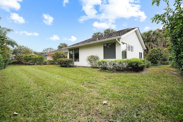 view of side of home with a lawn