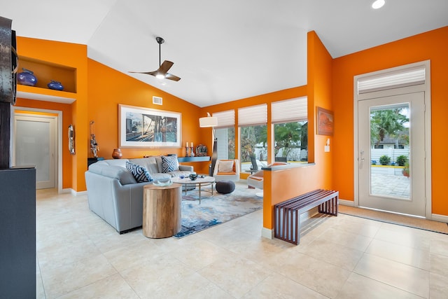 living room featuring ceiling fan, light tile patterned flooring, lofted ceiling, and built in features