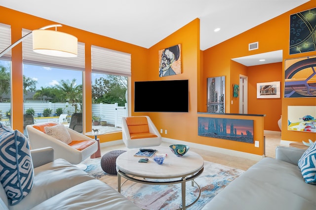 tiled living room with lofted ceiling