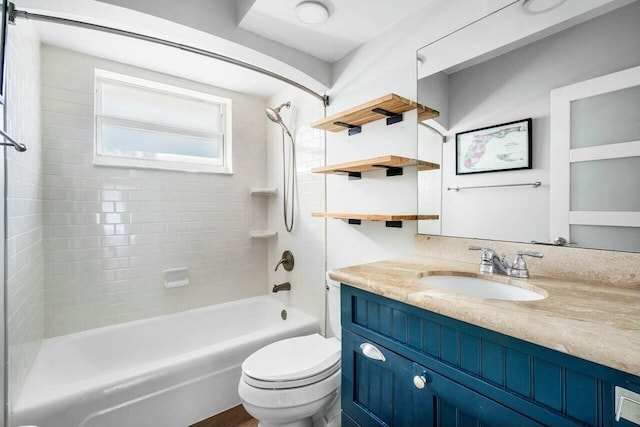 full bathroom featuring vanity, tiled shower / bath combo, and toilet