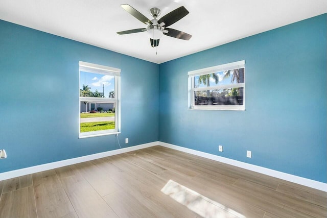 spare room with ceiling fan and light wood-type flooring