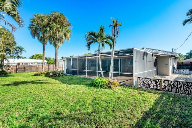 view of yard with glass enclosure