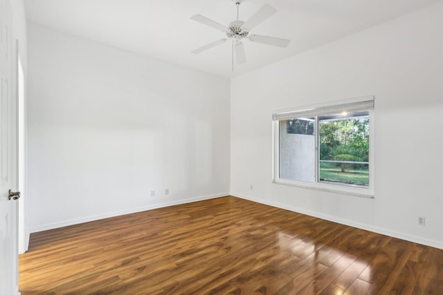 empty room with ceiling fan and dark wood-type flooring