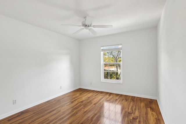 spare room with ceiling fan and dark wood-type flooring