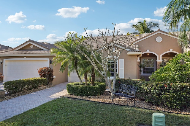 view of front of home with a front lawn and a garage