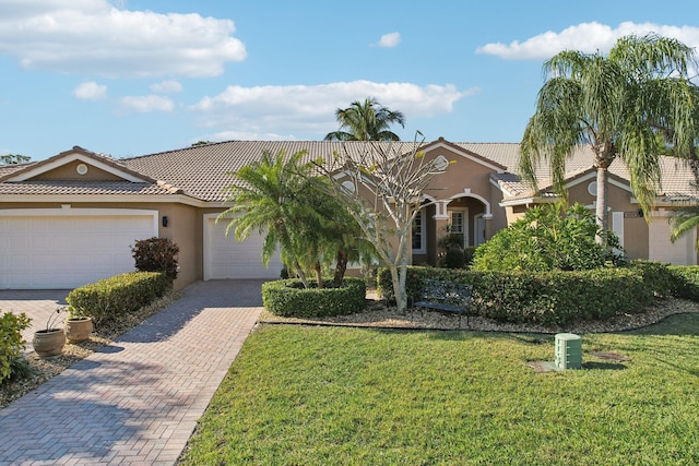 view of front of home with a garage and a front lawn