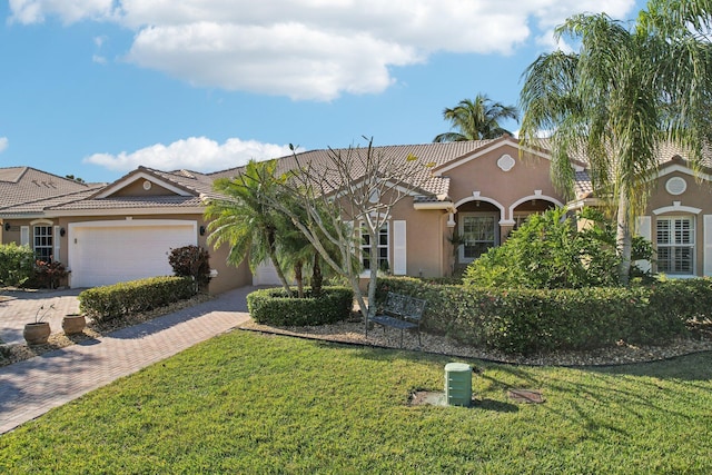 view of front of home featuring a garage and a front lawn