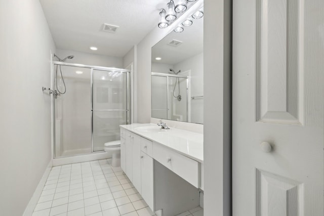 bathroom featuring toilet, a textured ceiling, a shower with shower door, and vanity